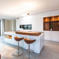 Küche Kücheninsel Großzügig Clean Wand Weiß Matt Walnuß Walnußholz Theke Holz Blanco Spüle BORA Kochfeld Miele Kaffeemaschine Dampfgarer Backofen Arbeitsplatte Glasarbeitsplatte Ausladend Regal Kieppe Planung individuell persönlich Beratung 
